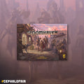 Gloomhaven board game box with characters and architecture illustration on a pinkish-purple background.