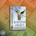 The book 'Wingspan Pocket' by Elizabeth Montgomery and Patricia Ryan is shown standing upright. The cover features a light blue sky background with an illustration of a yellow bird, an orange and black bird, and a nest.