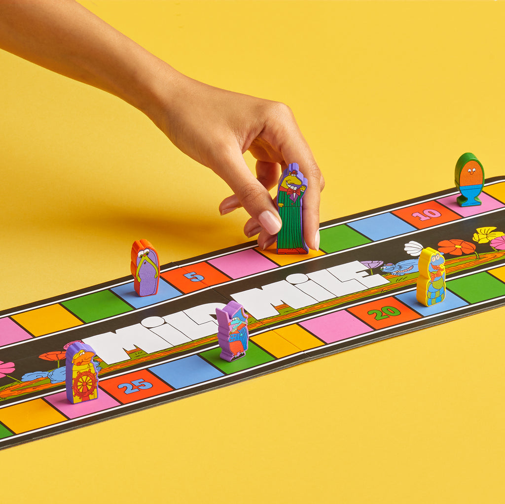 Colorful board game with player pieces on a yellow background