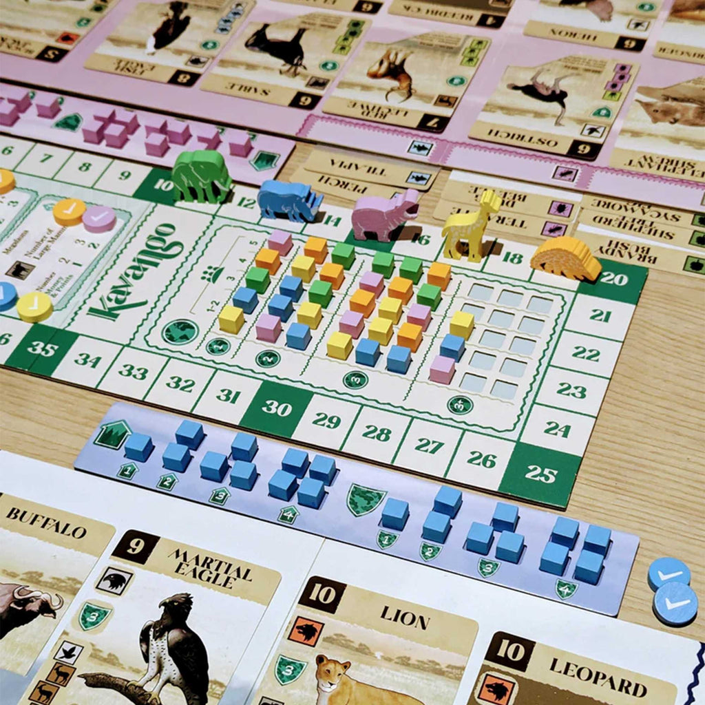 Board game with colorful pieces and cards on a wooden surface