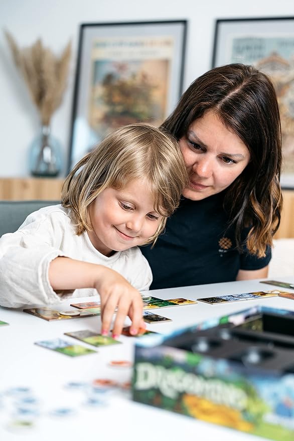 Woman and child playing a board game together in a cozy room.