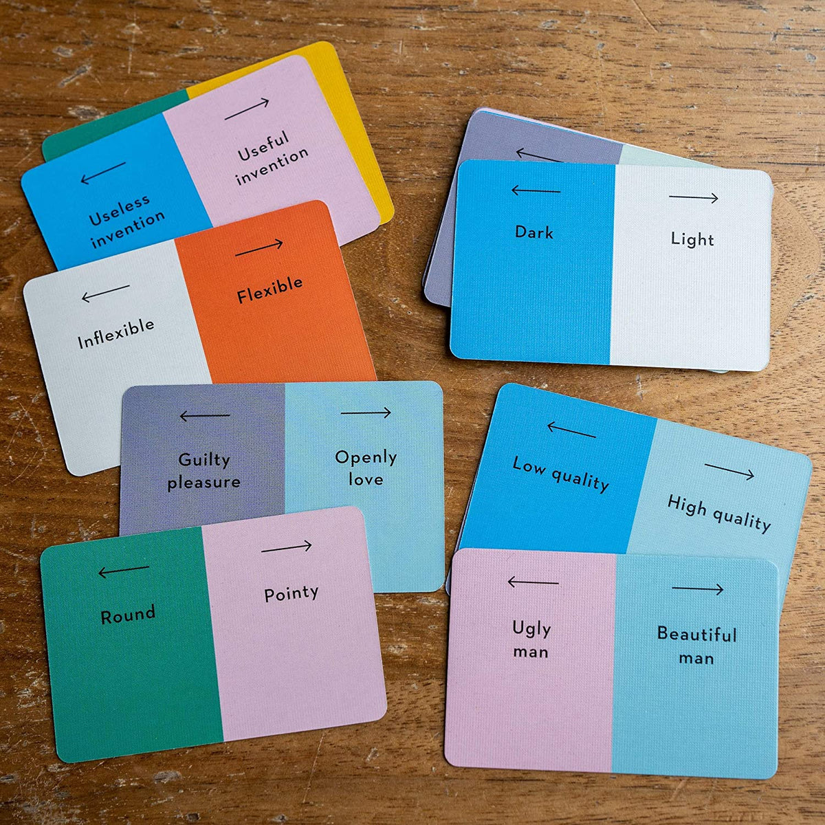 Colorful cards with black text on a wooden surface