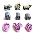 Set of animal and fruit-shaped wooden tokens on a white background