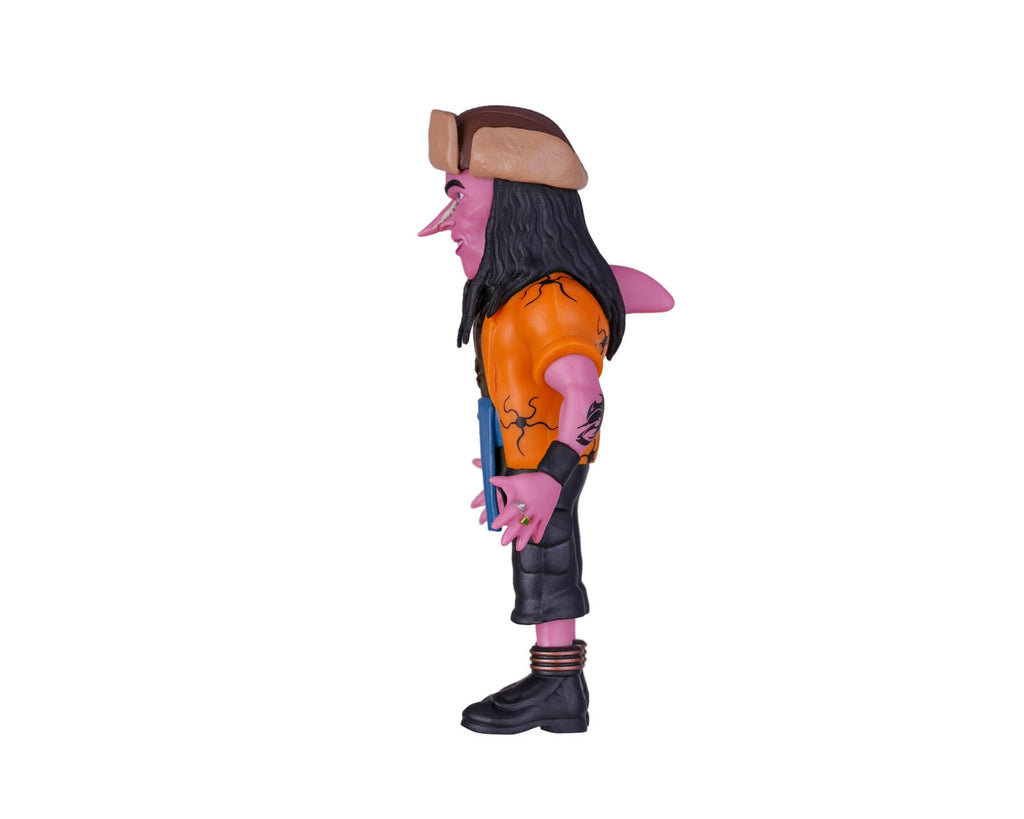 A stylized side-profile action figure of a pink-skinned character with long black hair, a brown hat, an orange top, and black shorts and boots, shown on a plain white background.