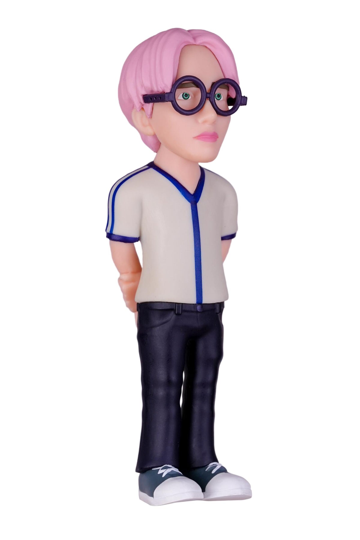 A stylized bobblehead figurine of a character with pink hair, round black glasses, a beige and blue V-neck shirt, dark pants, and white sneakers, shown against a plain white background.