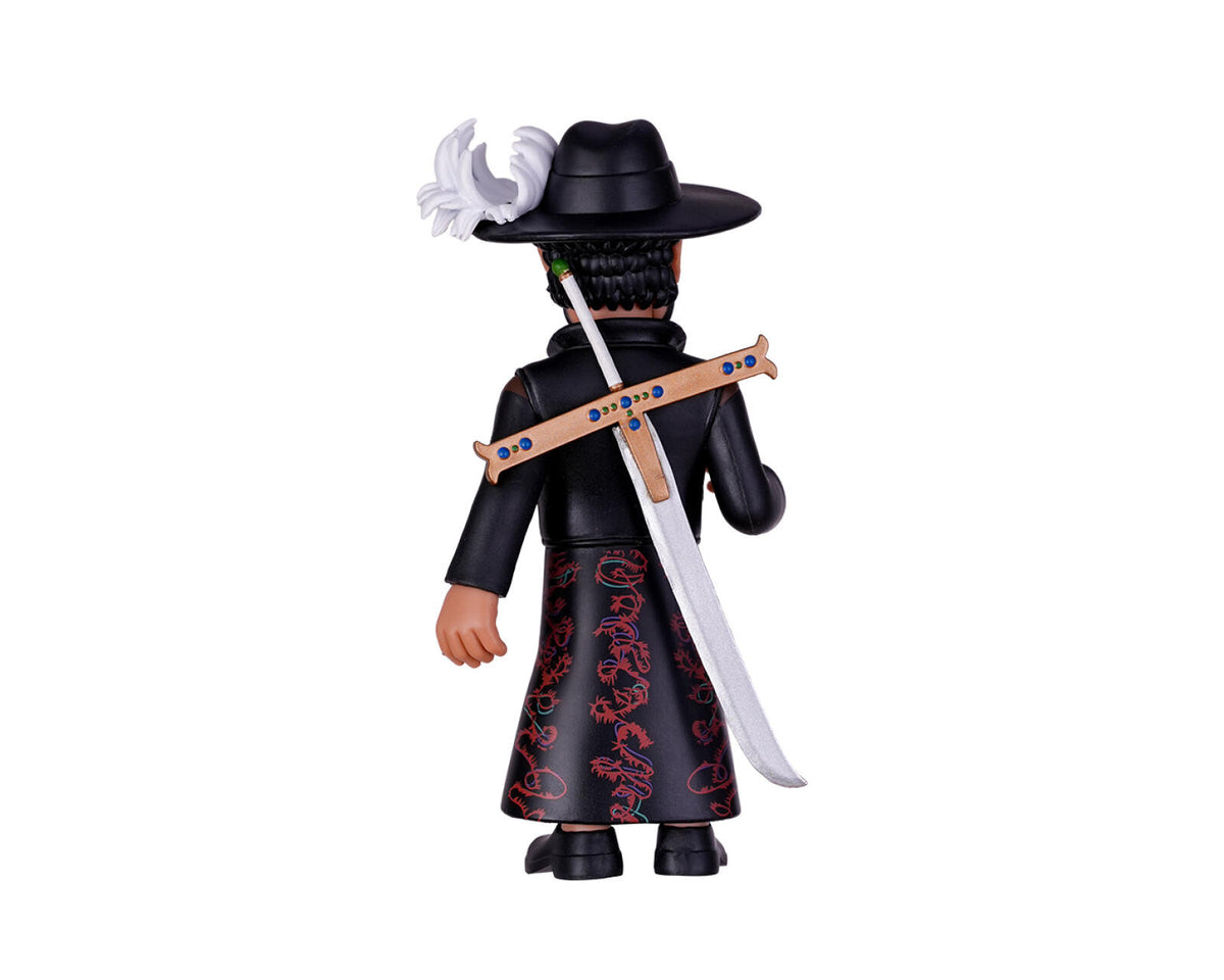A collectible action figure of a character from One Piece, shown from the back. The figure is wearing a black hat with a white feather, a black outfit with red dragon patterns on the skirt, and has a large sword strapped over the shoulder.