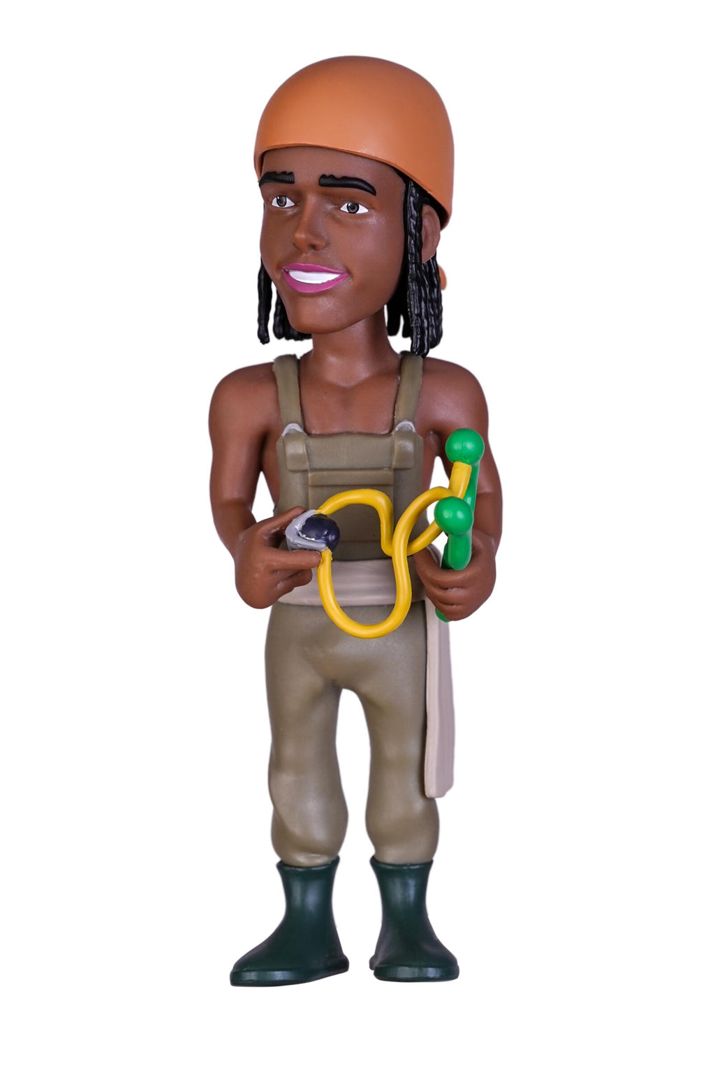 A stylized bobblehead figurine of a person wearing an orange helmet, tan overalls, and dark green boots, holding a yellow hose and a green tool against a plain white background.