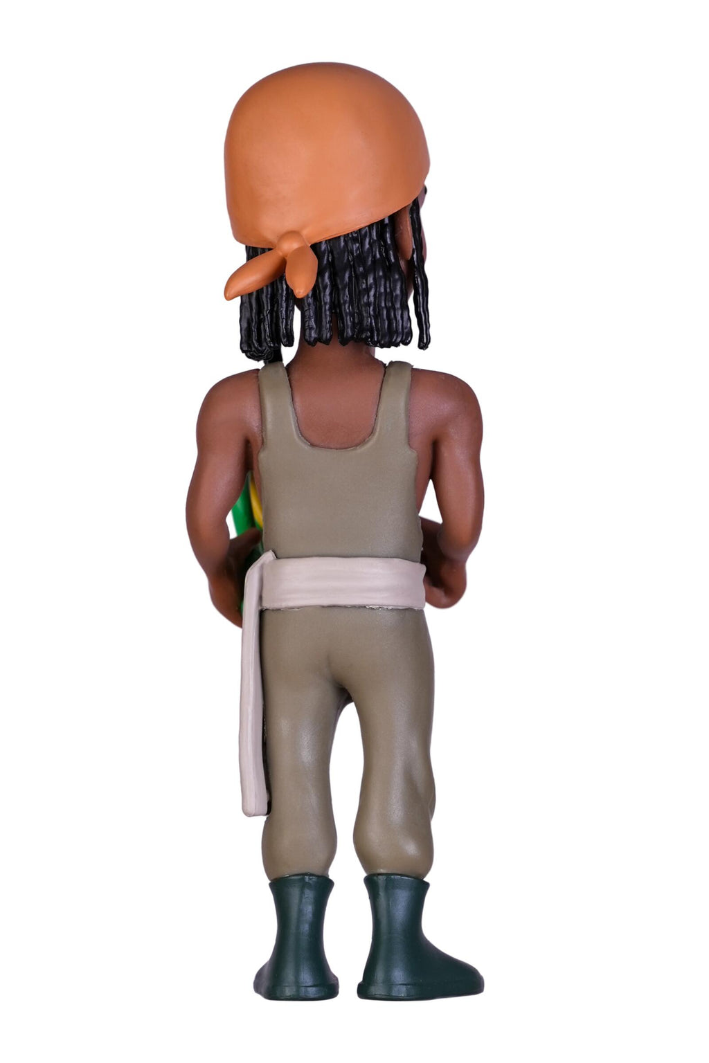 A stylized bobblehead figure of a man seen from the back, wearing a tan sleeveless top and pants, a light beige waist wrap, dark green boots, and a peach-colored head covering with black braids, set against a plain white background.